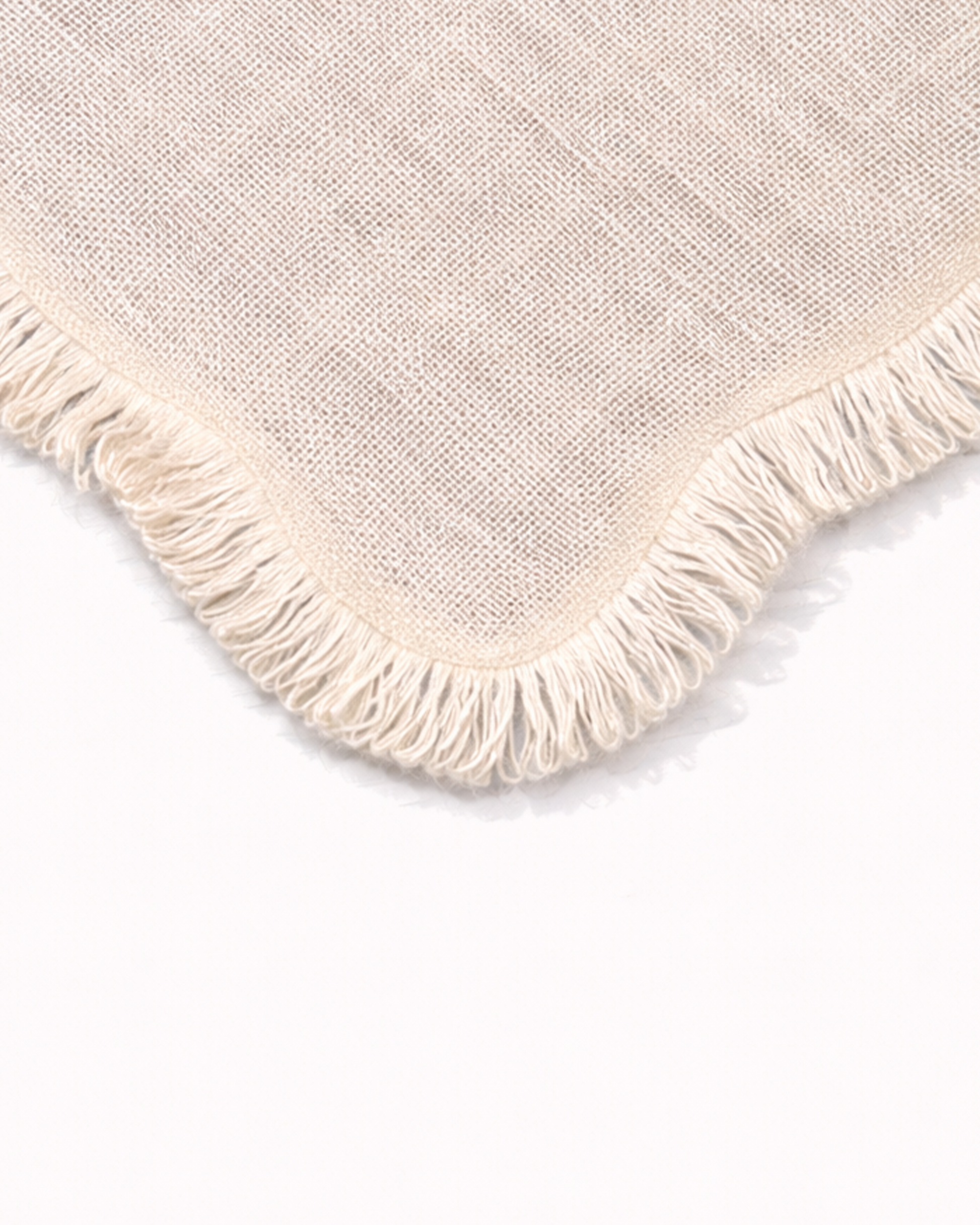 Close up of light jute placemat with fringed edges front view