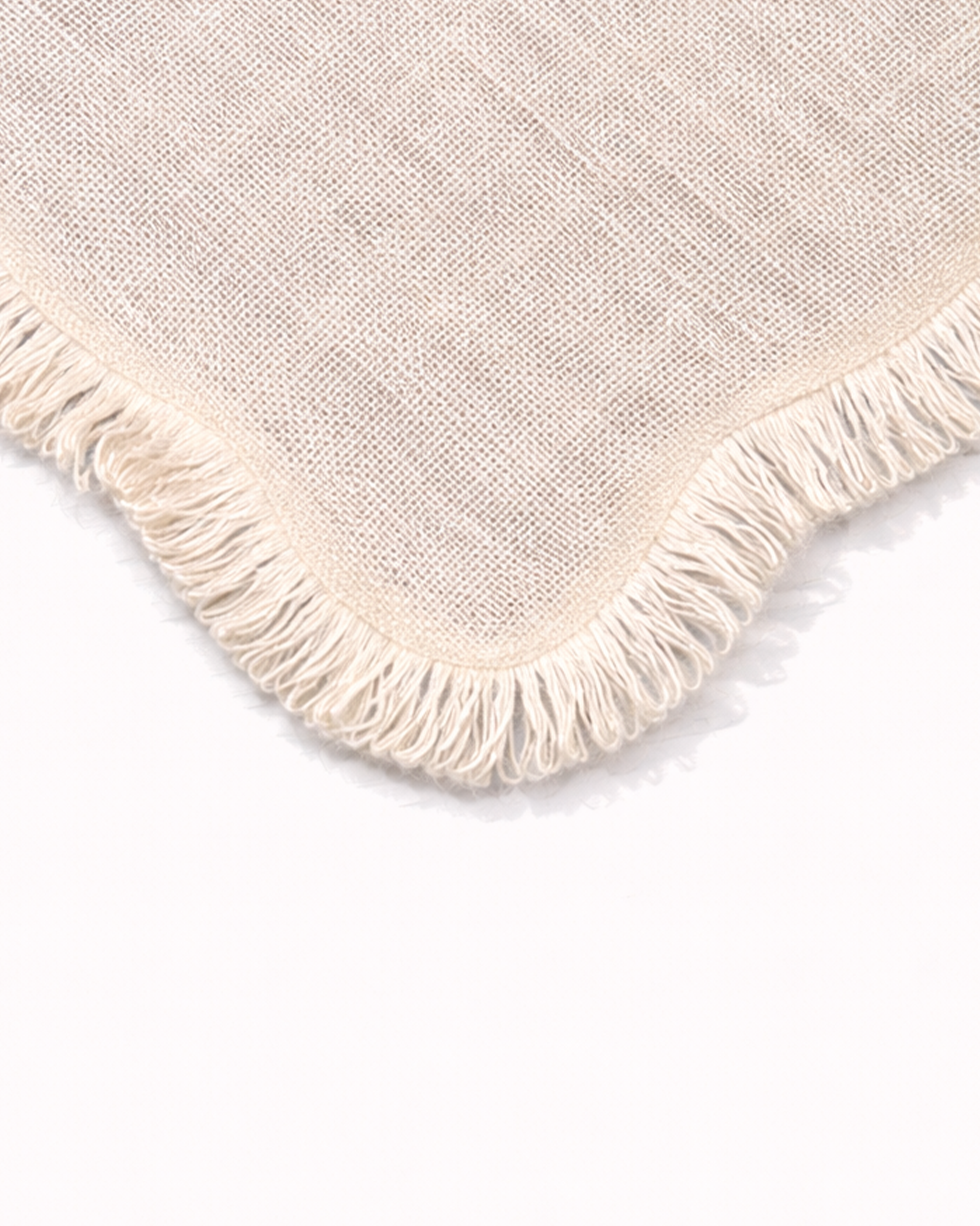 Close up of light jute placemat with fringed edges front view