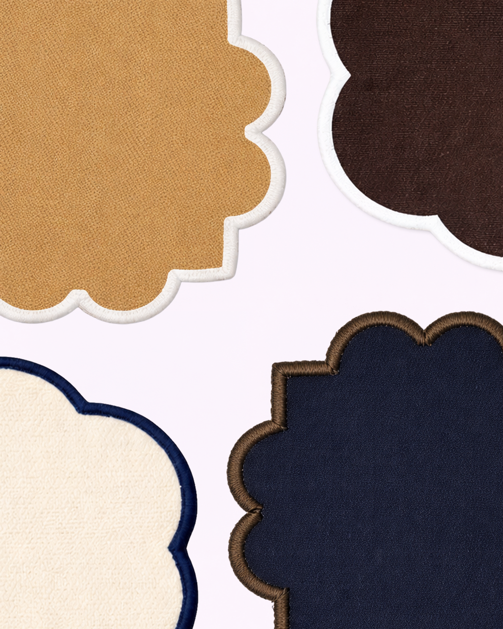 Close-up of cotton coasters in camel, chocolate brown, navy blue and off-white front view