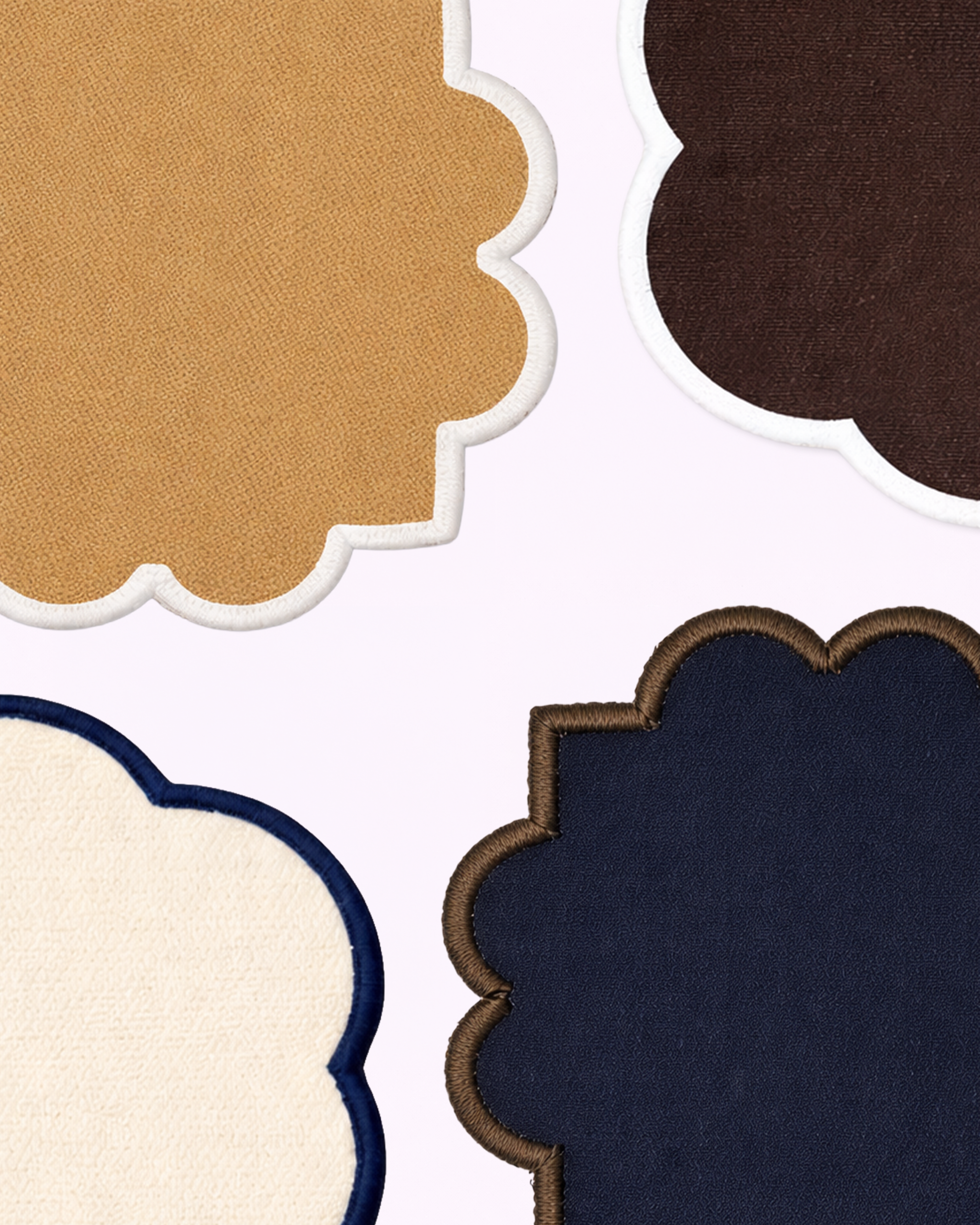 Close-up of cotton coasters in camel, chocolate brown, navy blue and off-white front view