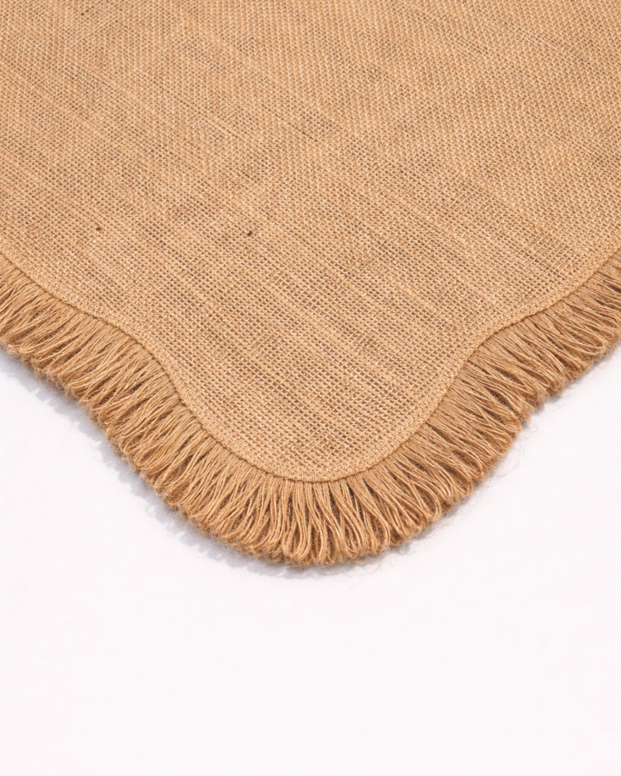 Close-up of a natural jute placemat with fringed edge front view