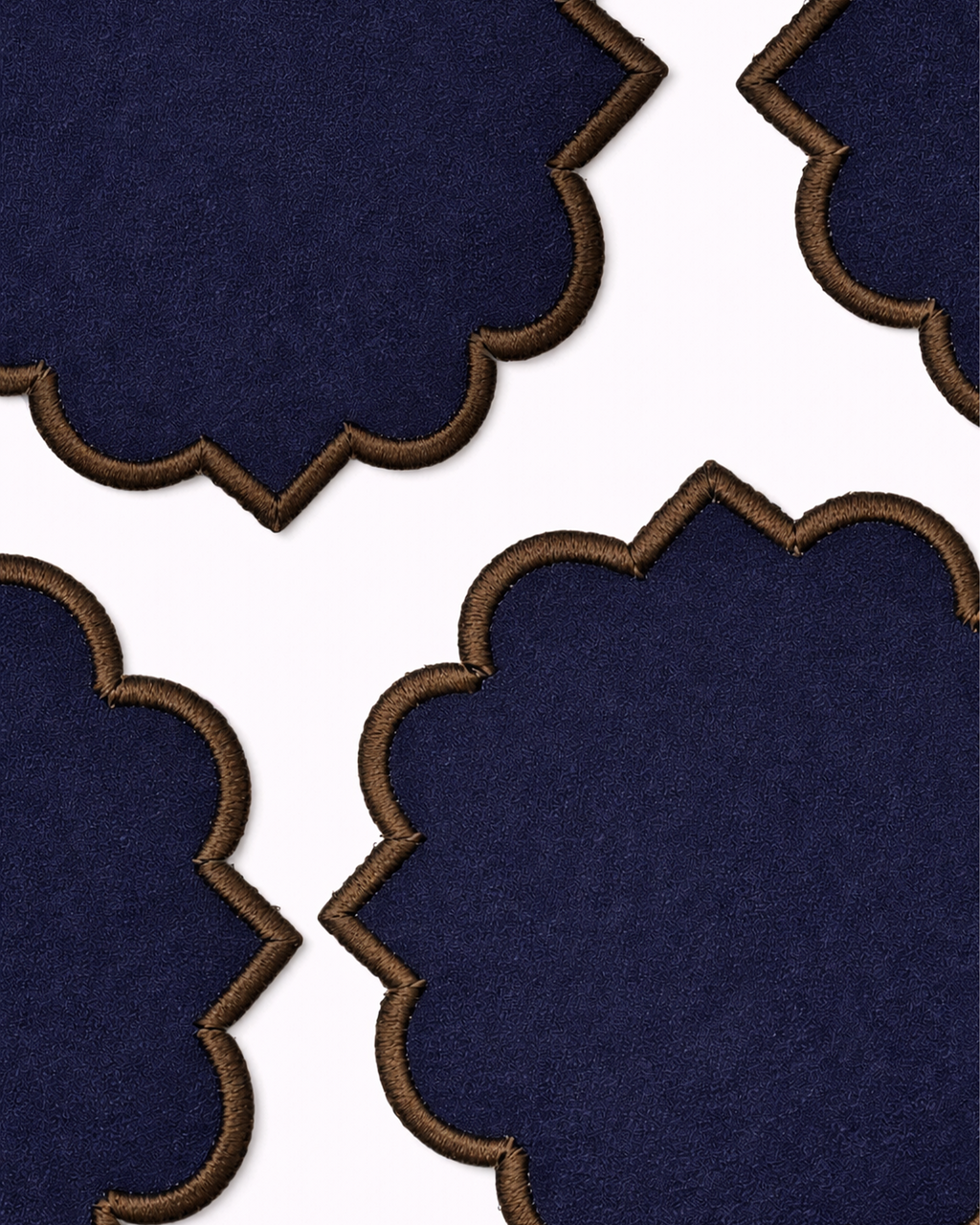 Close up of four navy blue cotton coasters front view