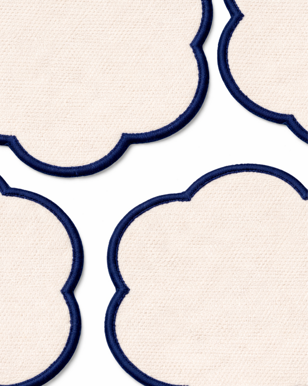 Close up on a set of four off-white cotton coasters front view