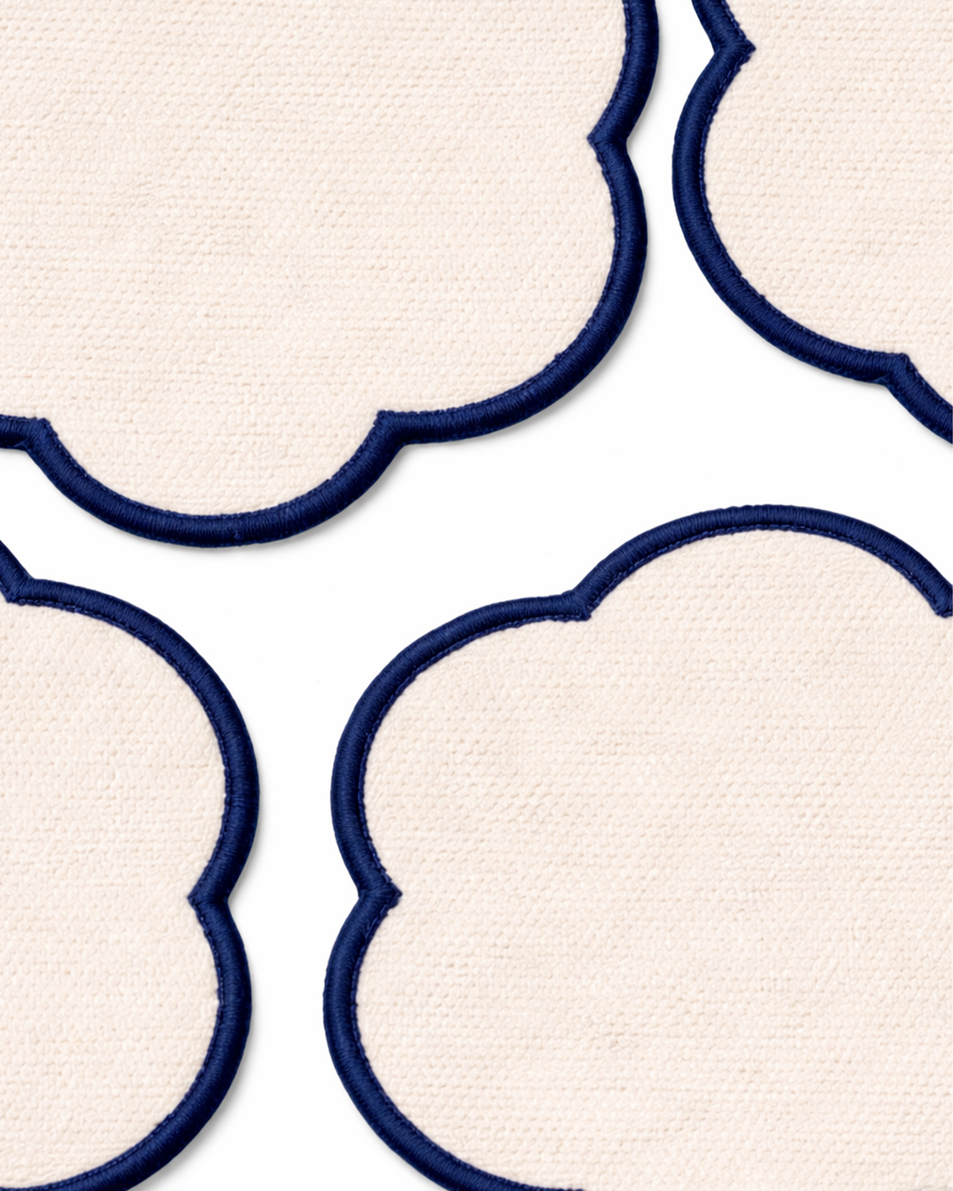 Close up on a set of four off-white cotton coasters front view