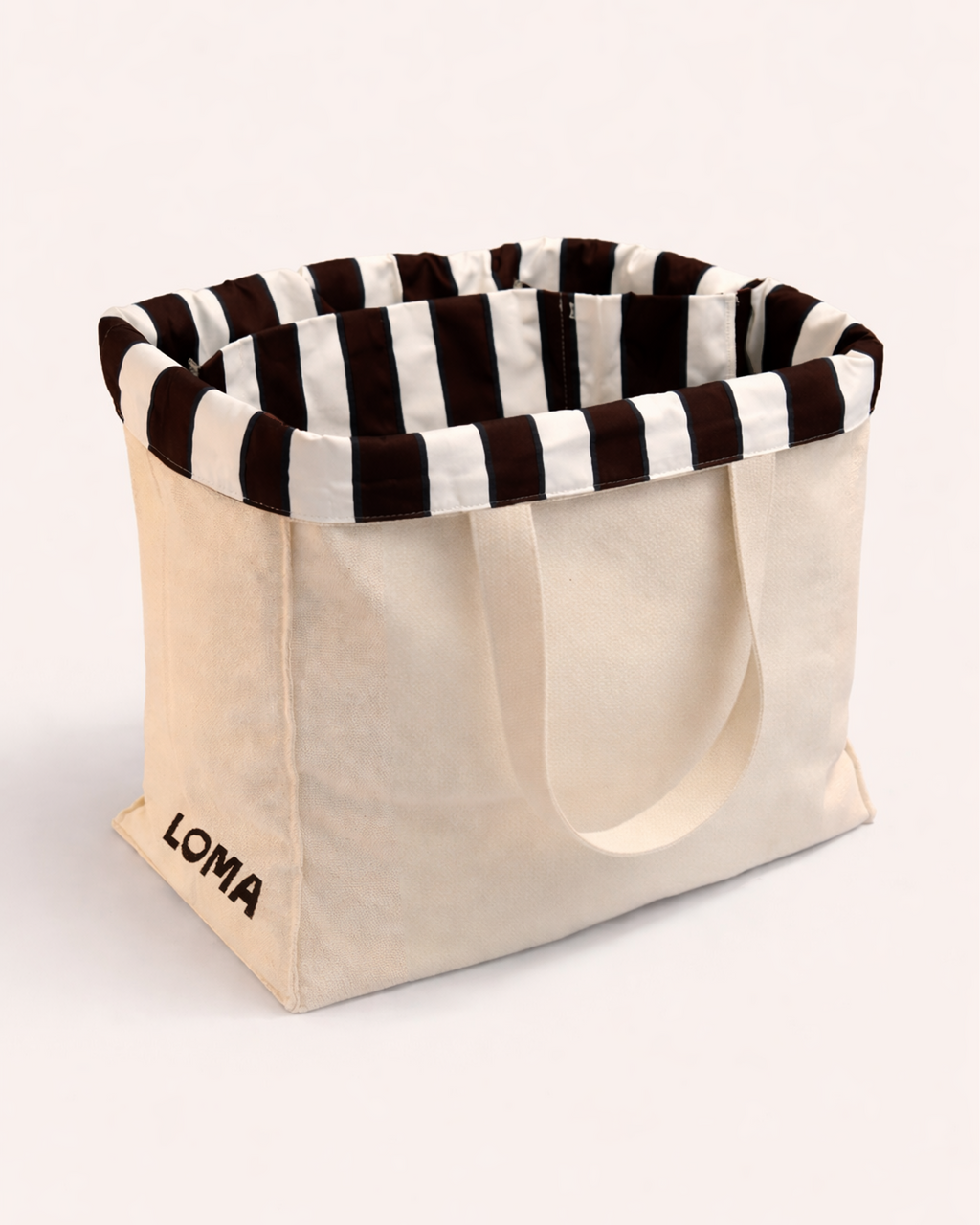 Cotton tote bag with striped interior and white shoulder straps side view