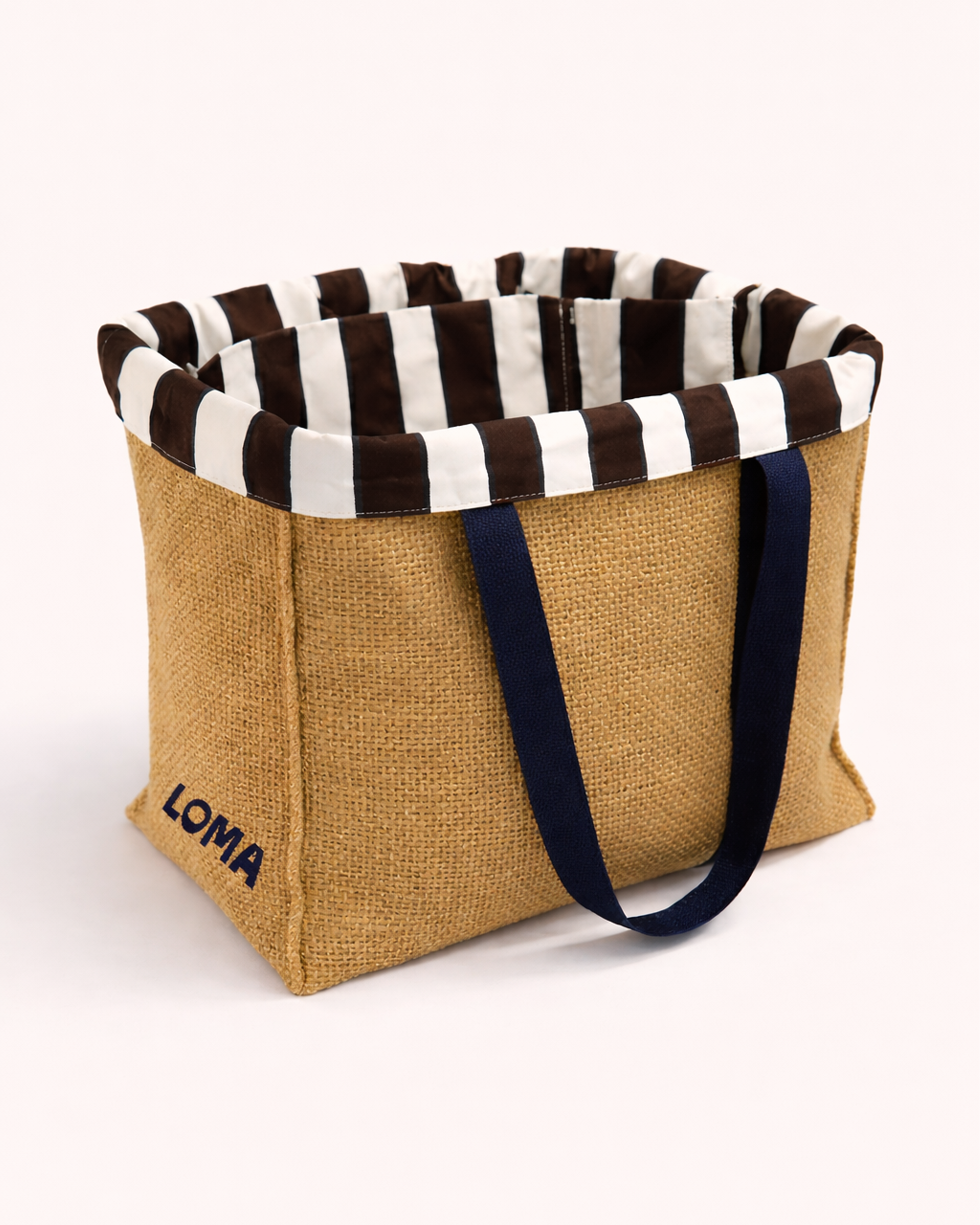 Jute tote bag with striped interior and blue shoulder straps side view