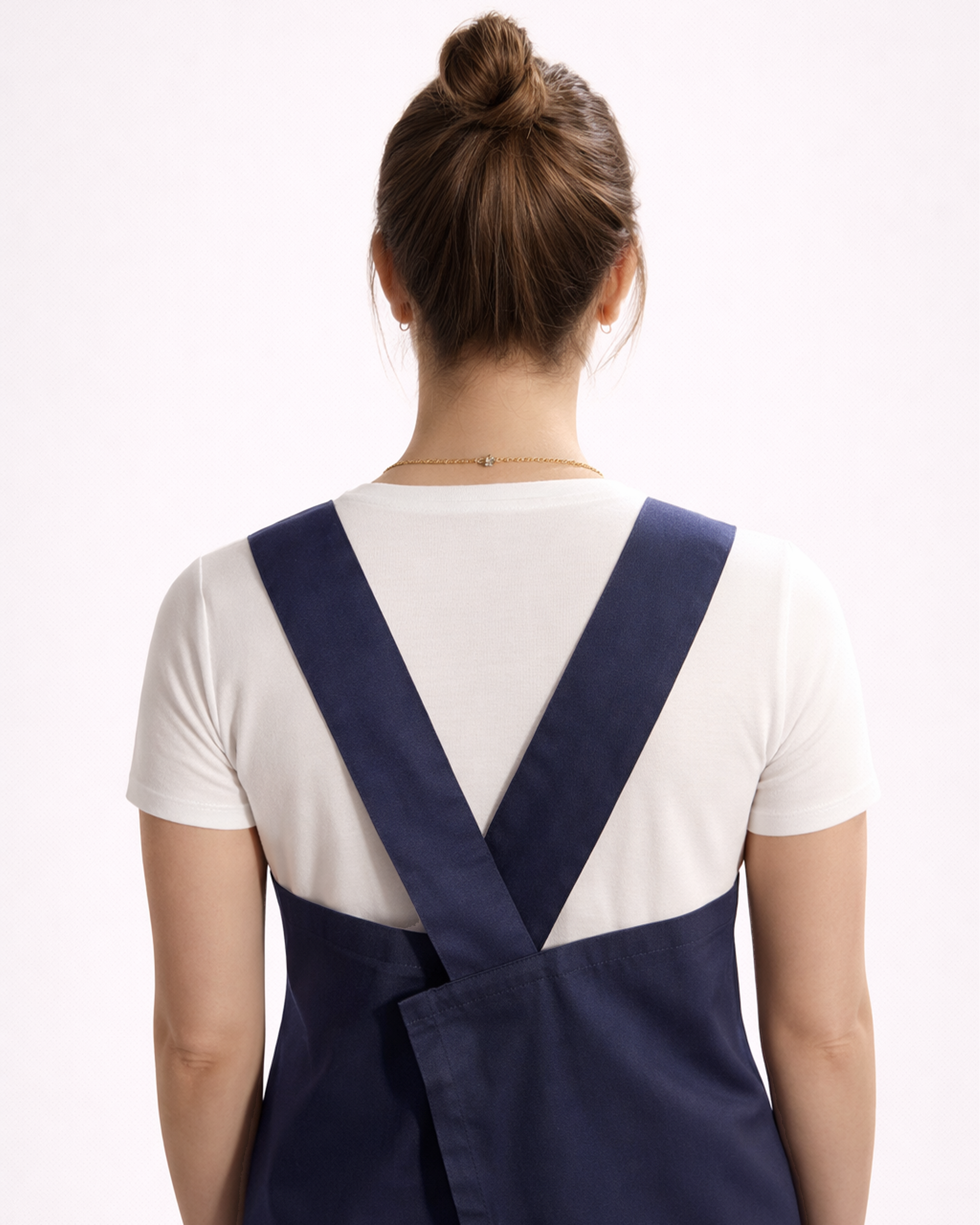 Woman wearing a navy blue cotton apron back view