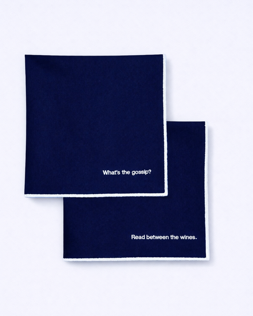 Set of two navy blue napkins with embroidered quotes in white front view
