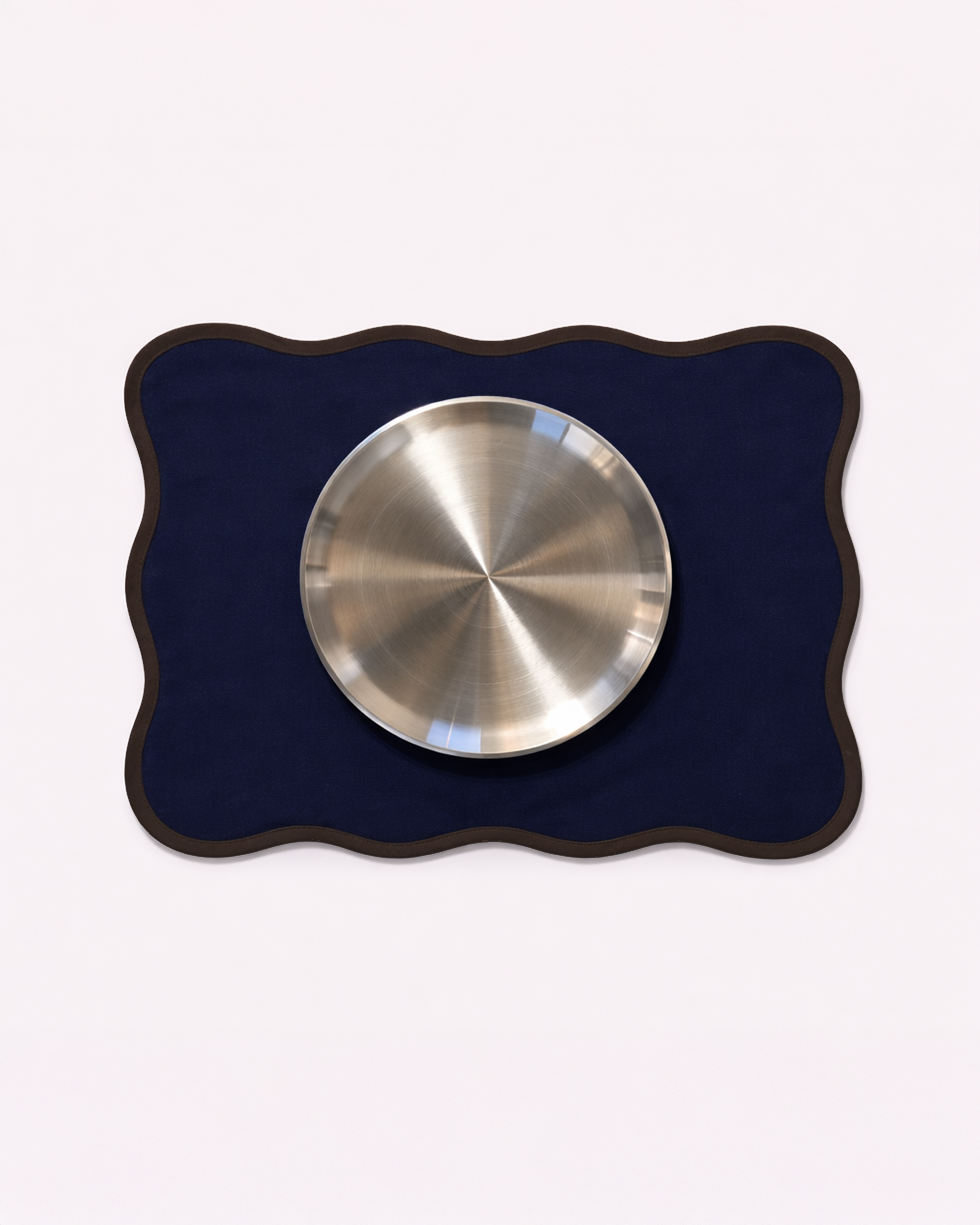 Navy blue cotton placemat with chrome tableware front view