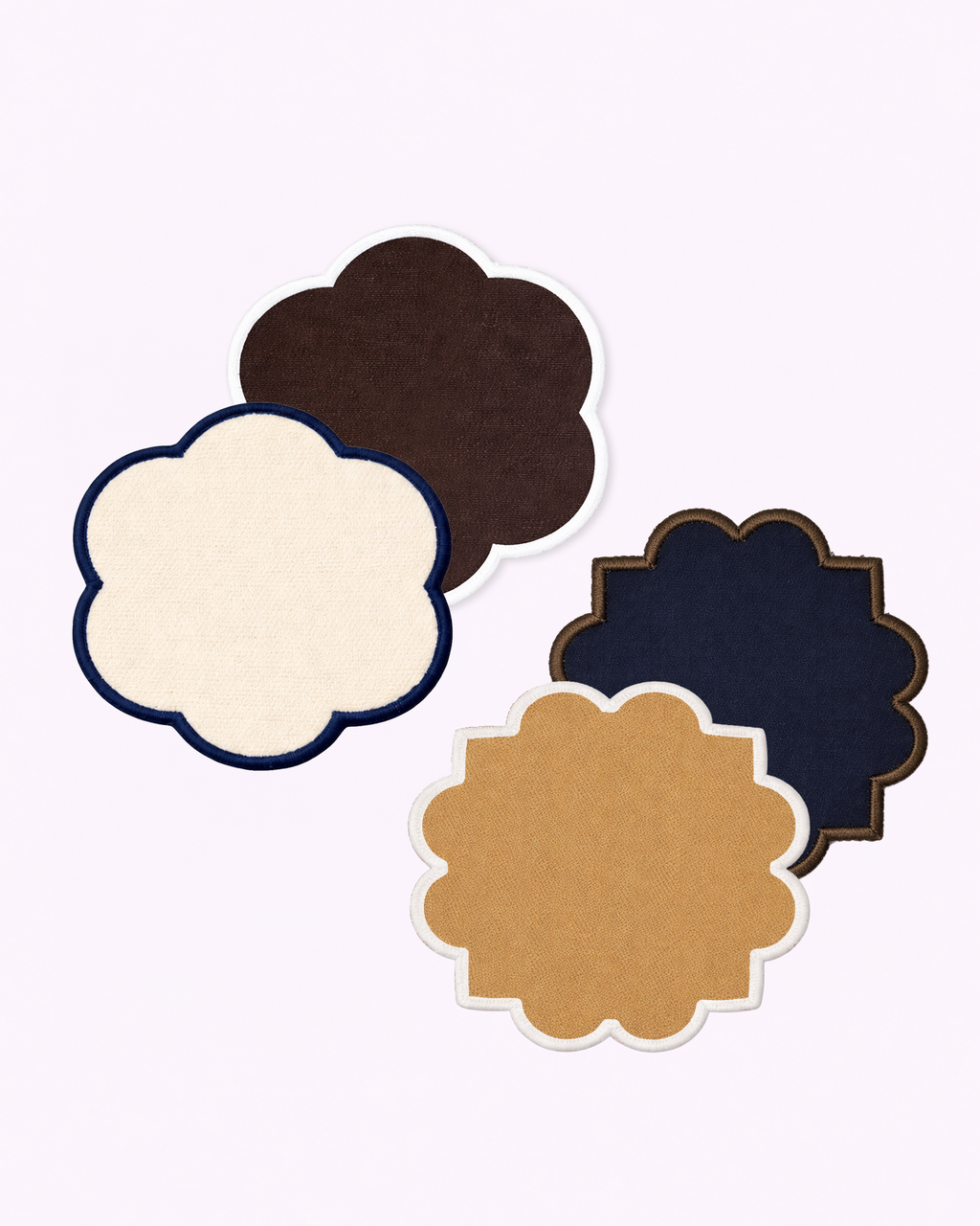 Set of four coasters in off-white, chocolate brown, camel and navy blue front view