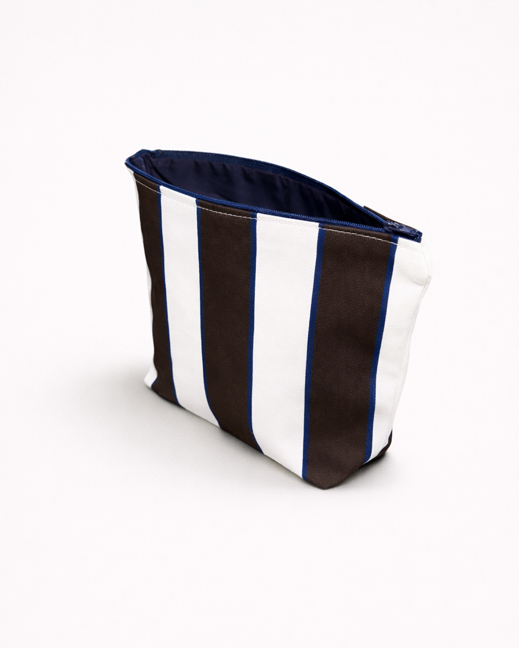 Striped toiletry bag with brown and white pattern and an open blue zipper side view